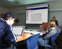 Professor Lay incorporates multiple technologies into her class, including the Sympodium/SMART Board and wireless internet-connected student laptops.