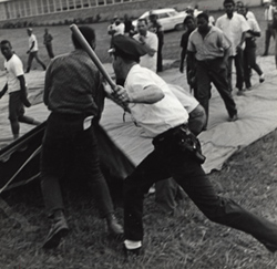 Police officer holding raised baton. Birmingham, AL. Harry Wachtel Collection