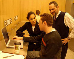 Professor with students at wireless cafe
