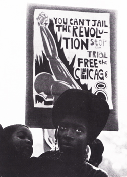 Woman and child in front of Chicago 8 protest poster. Used by permission of Alan Copeland.