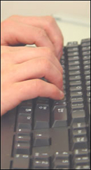 user typing on keyboard