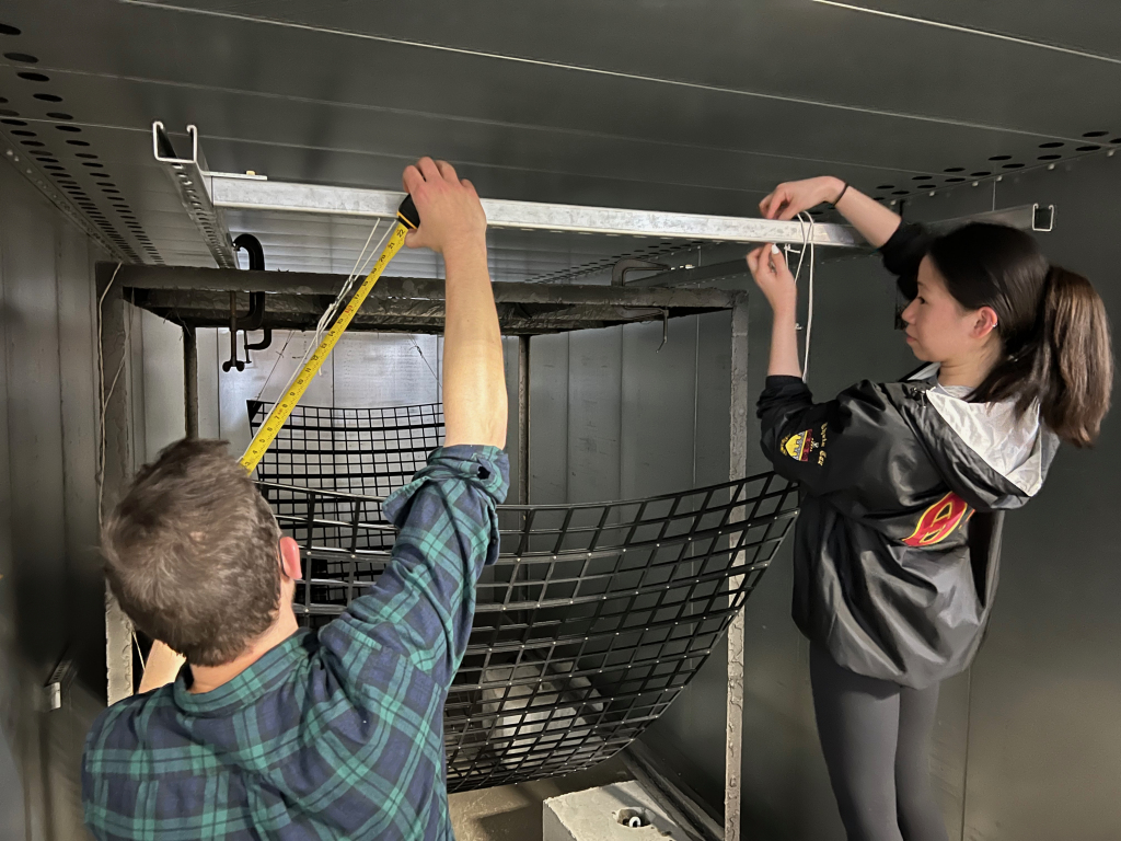 Esther and Professor Segal hanging the project in the industrial oven at a facility in Bethpage, NY.