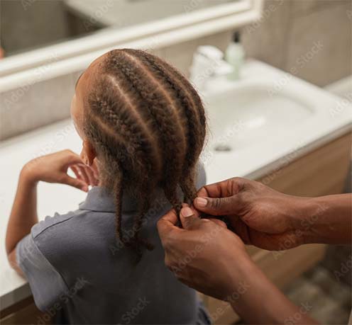 Dad braiding daughter's hair