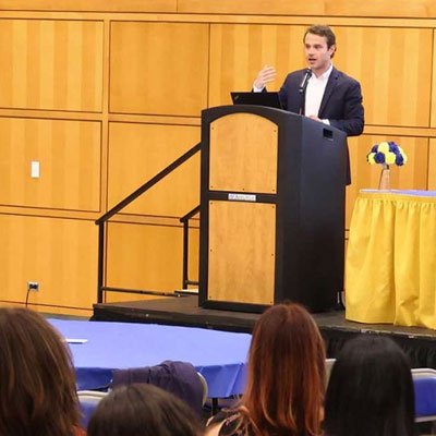 Man making a presentation while standing behind a podium 