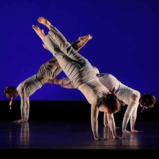 3 students dancing on stage