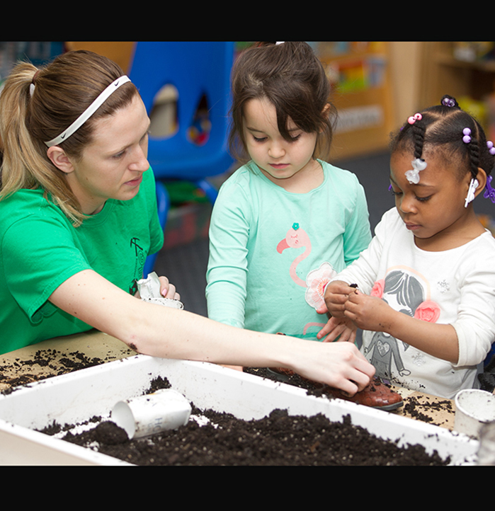 Student planting with children