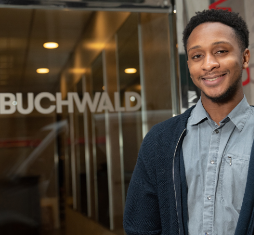 Student standing in front of Buchwald PR office building. 