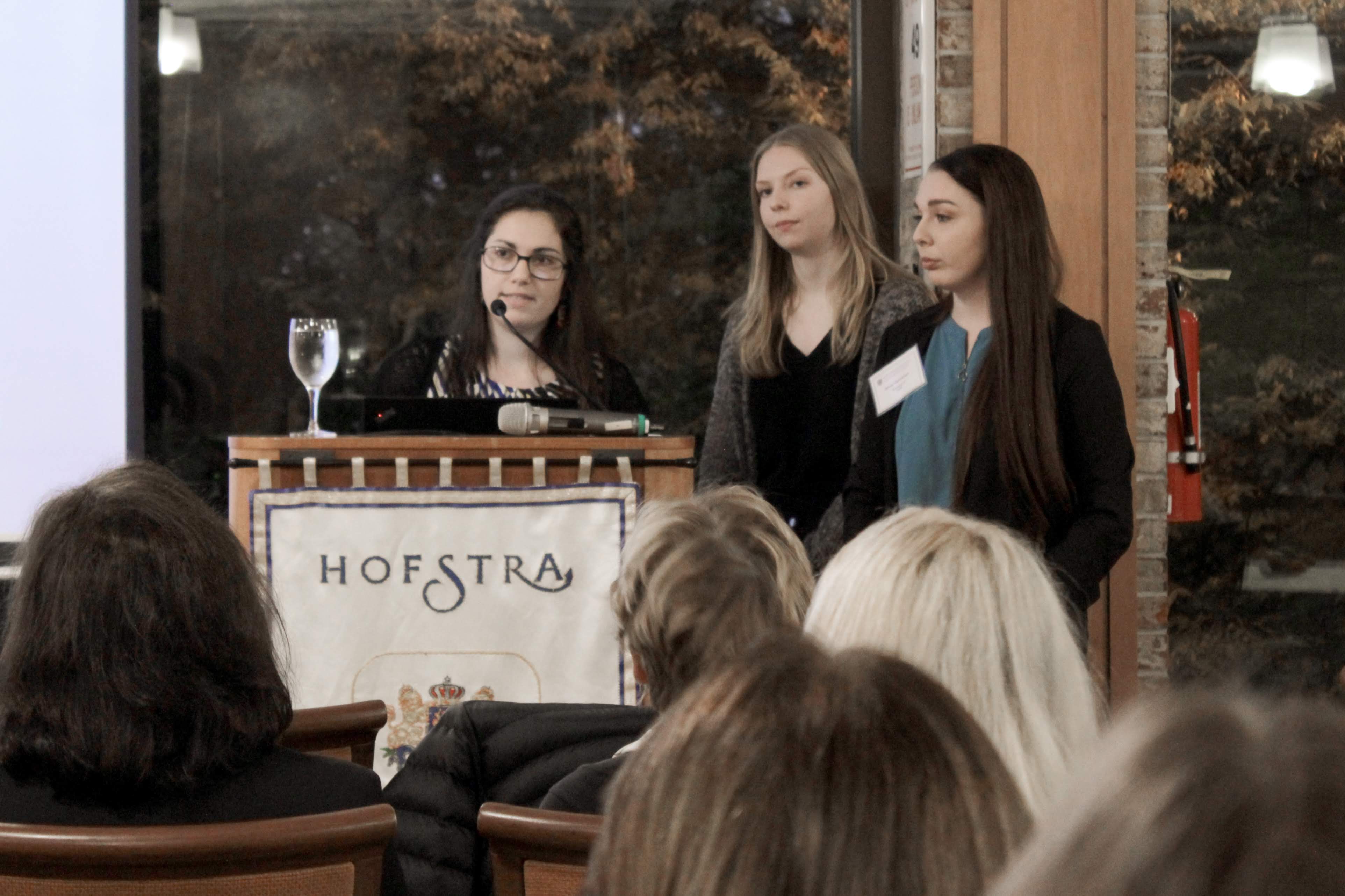 Three female students speaking at event