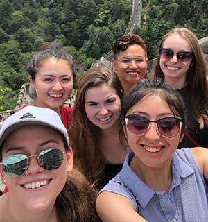 Students smiling on the Great Wall of China