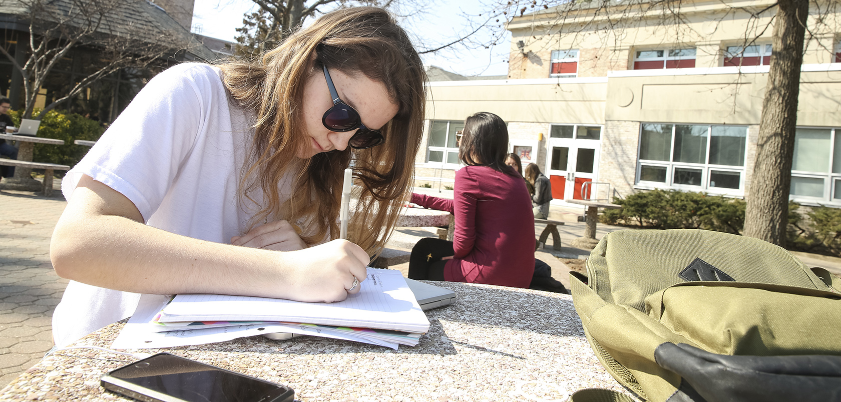 Student writing outside