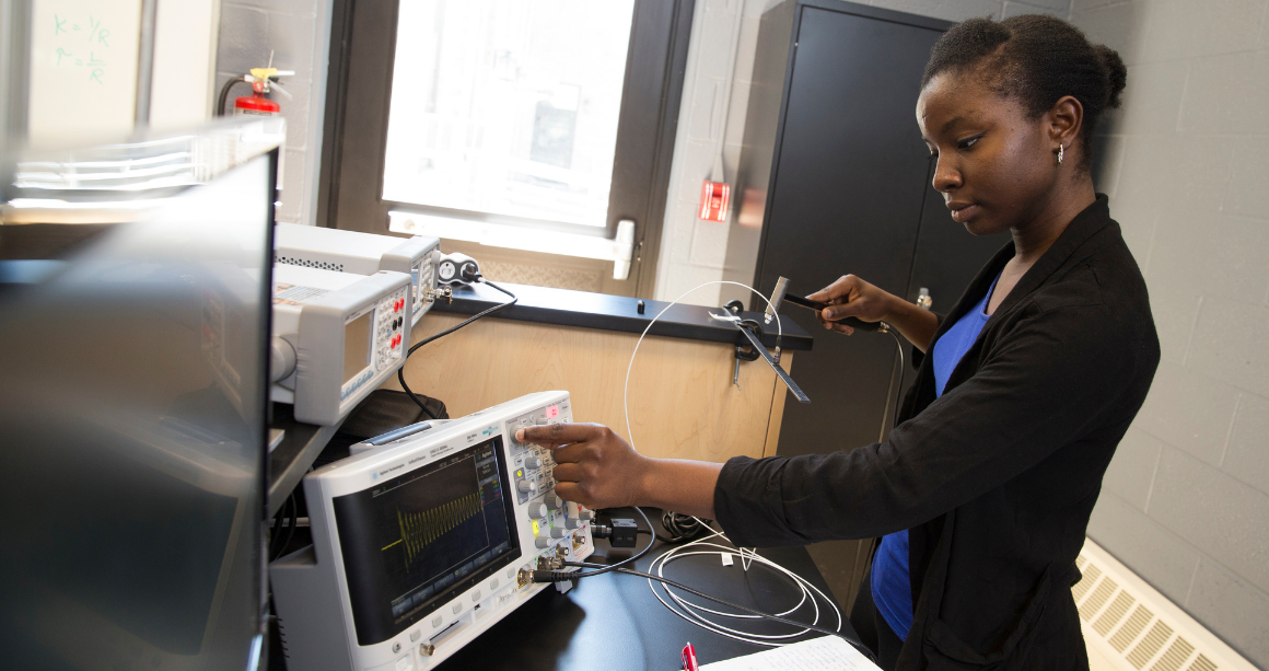 Electrical engineering student working with equipment