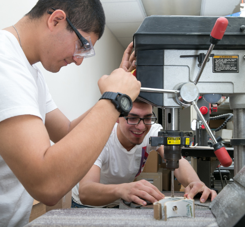 engineering students using machinery