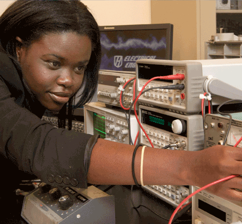 Woman student works on engineering equipment. 