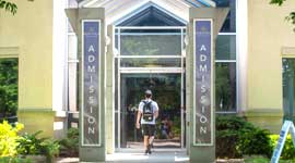 Student walking through admission doorway