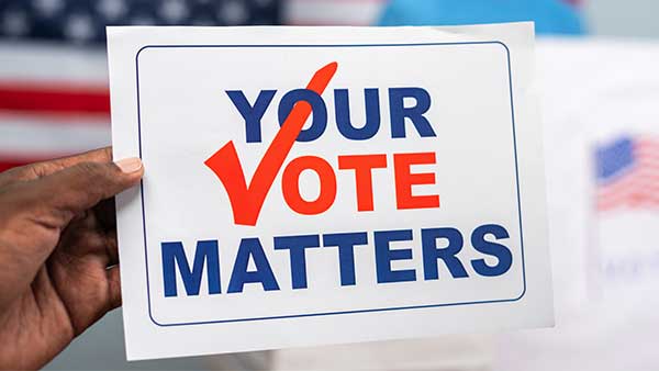 hand holding sign that reads "Your Vote Matters"
