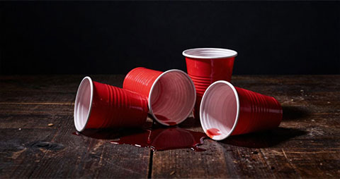 4 red solo cups on the floor