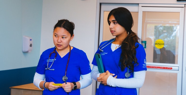 Student nurses observing patient