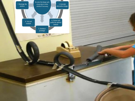 child constructing a roller coaster experiment