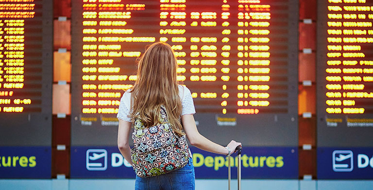Female student looking at departure schedule