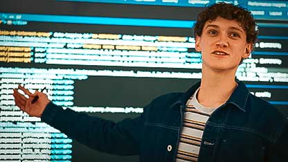 Student in front of Code