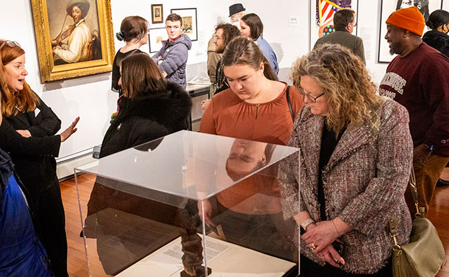 Visitors looking at art pieces in museum