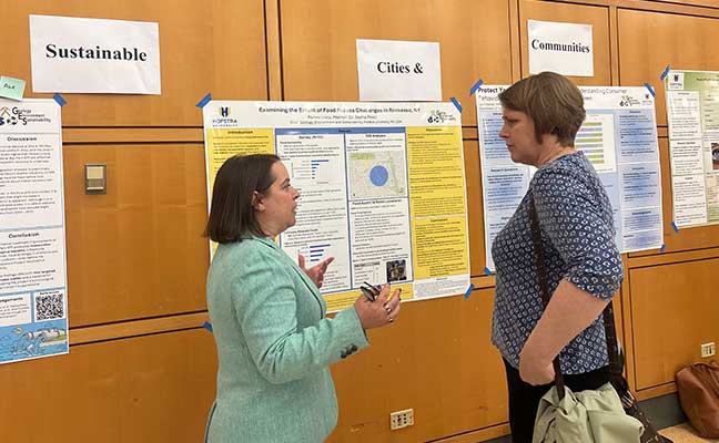 Renee Lista discussing her research poster during Graduate Research Day.