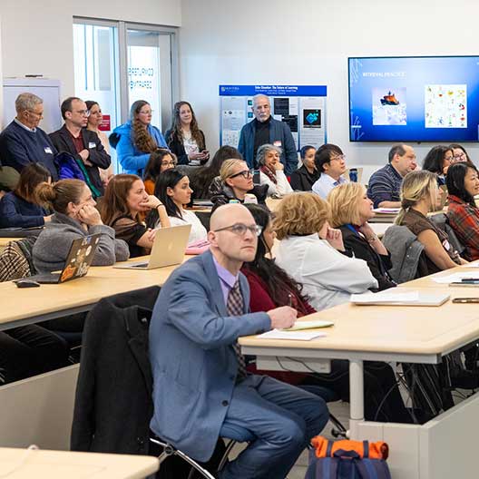 Faculty sitting in classroom lecture