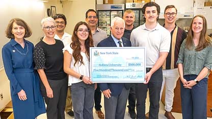 President Susan Poser, Biology Chair Jessica Ward, Professor Michael Dores, grad student Melodie Duran, Professor Javier Izquierdo, Assemblymember Charles Lavine, Professor Matthew Fisher, biology major Ryan Murphy, and Professors Alex Little and Brittany Miller.
