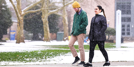 Students walking on campus in the snow